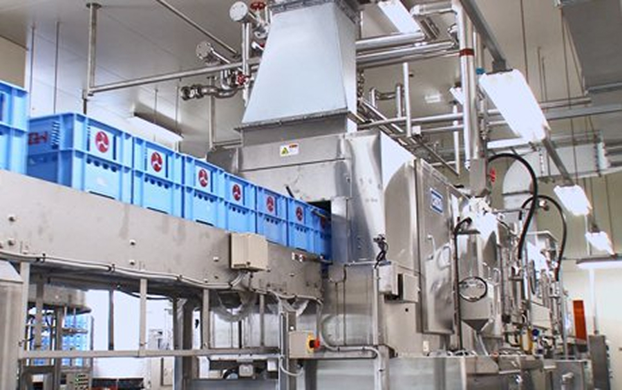 The crates are fed into the high-speed washer one after another.